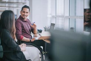 Image of two people interacting in an office environment